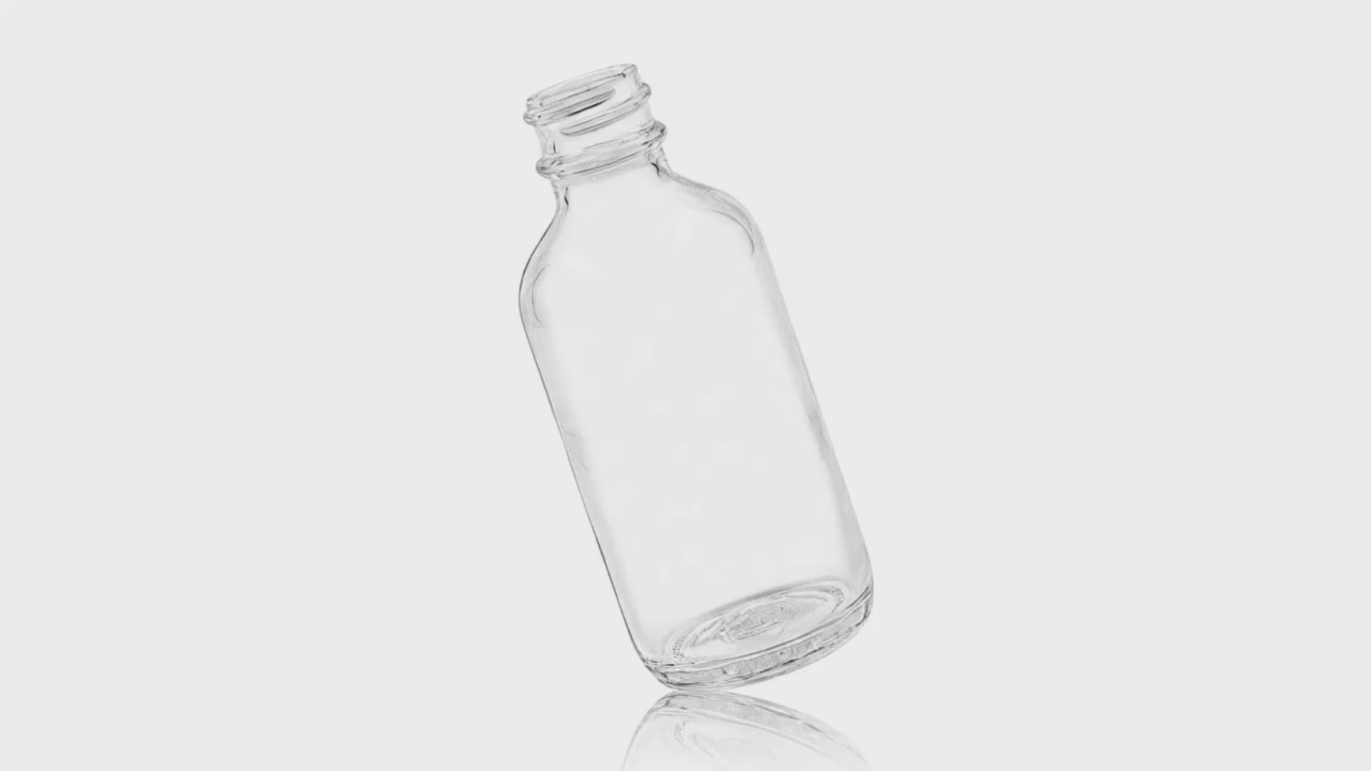 Load video: 2 oz Clear Glass Boston Round Bottle 20-400